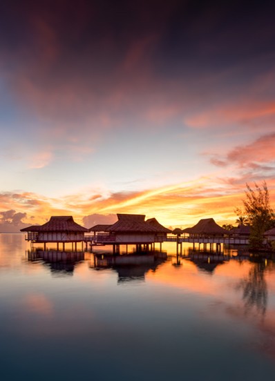 over water bungalows in French Polynesia at dawn