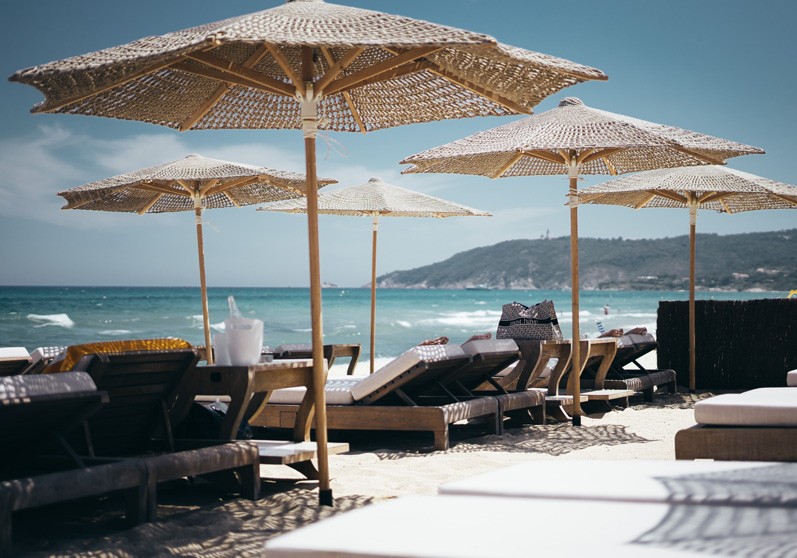 sun beds at a beach club at an yacht charter destination